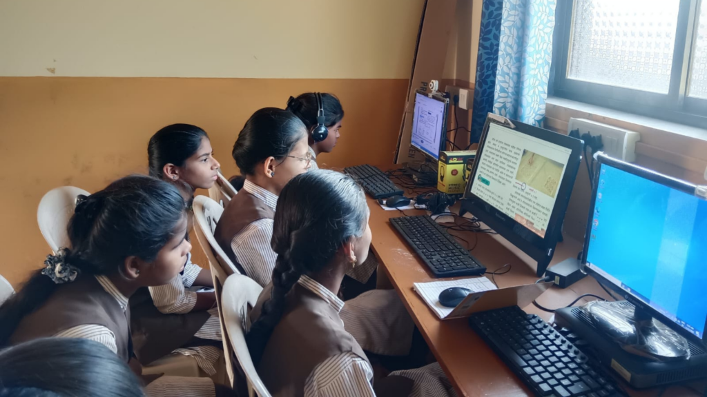 Tribal schoolgirls in Maharashtra learning computer skills in a newly equipped digital classroom provided by Apni Pathshala.