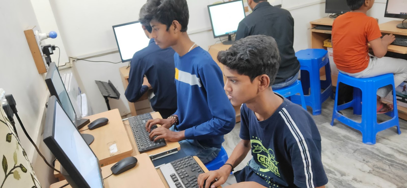 Kids getting computer education at Inspire Learning Center.