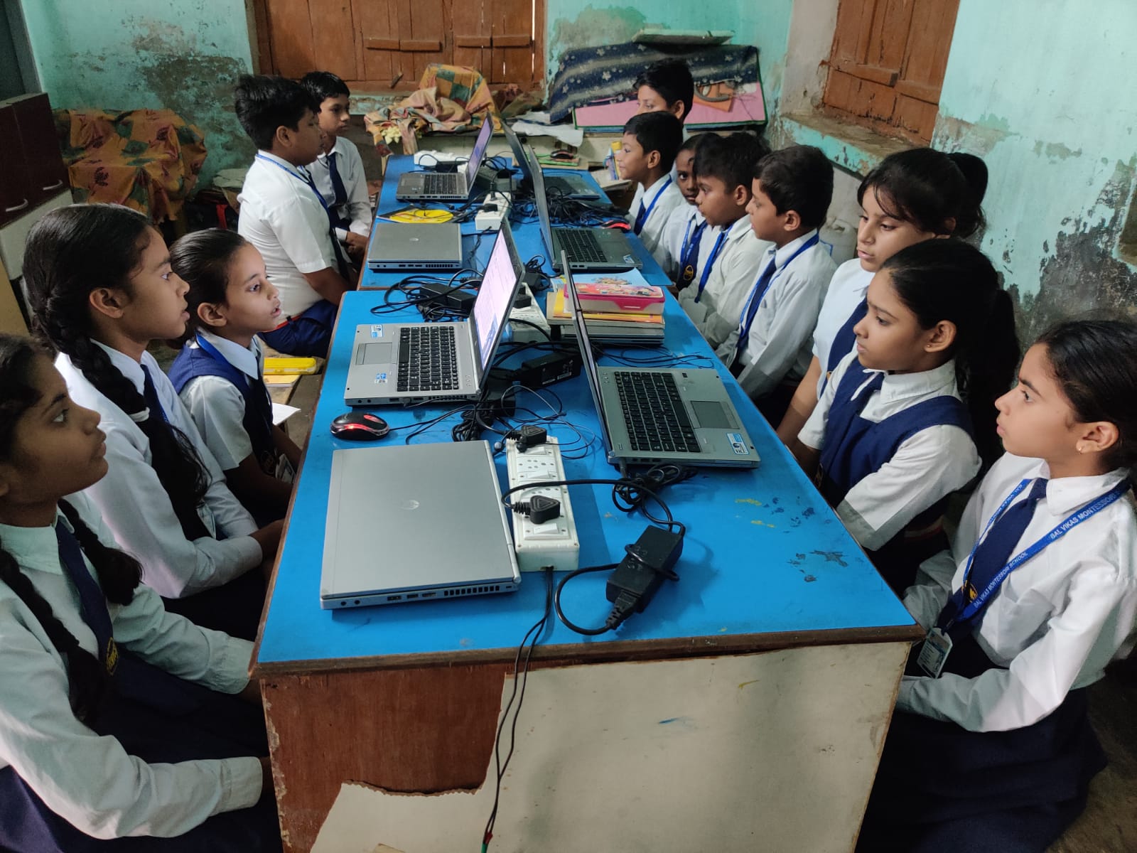 An illustration of a group of children using laptops at Bal Vikas Montessori School Lucknow, sitting in computer labs and operating computer systems to learn digital skills and resources