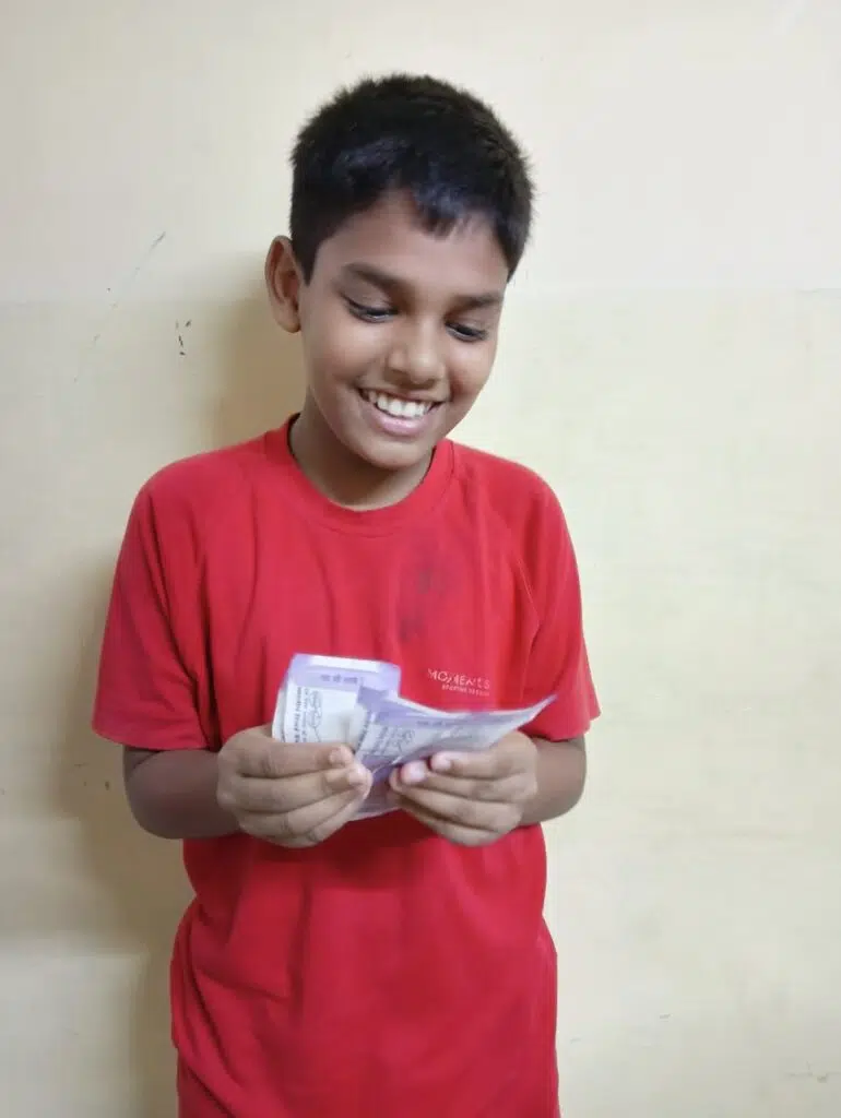 Picture of Ritesh with his first salary after this work in the classroom management and working on projects