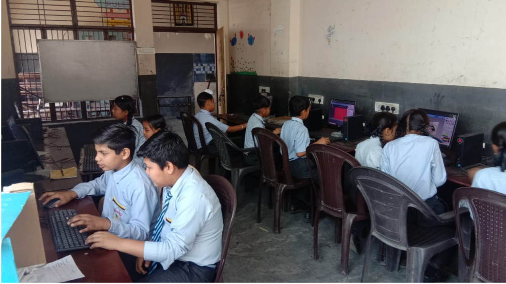 Students studying together in teams on personal computers in a community microschool.