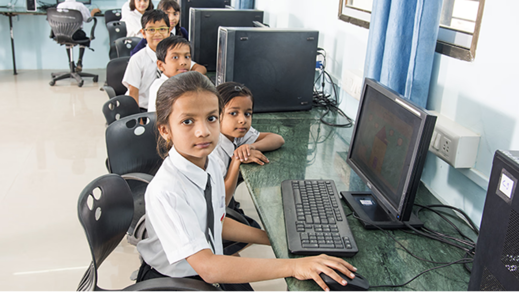 Children using computers in a classroom.